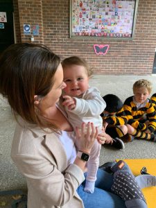 Happy woman and children playing outdoors at Inchmarlo Community Center.