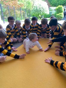 Young children engaging in educational activity outdoors at Inchmarlo.