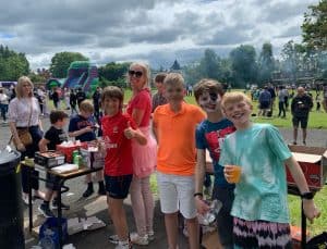 Family gathering at Inchmarlo with kids and outdoor activities in a scenic park setting.