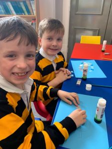 Two children engaging in arts and crafts at Inchmarlo nursery.