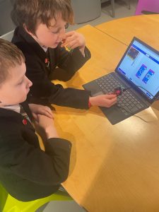 Two children engaged with educational computer activities at Inchmarlo.