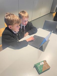 Two boys using a tablet at Inchmarlo, highlighting modern education facilities.
