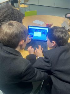 Two boys using a tablet at Inchmarlo school.