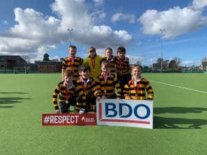 Young rugby players in striped jerseys on the field at Inchmarlo, promoting sportsmanship and teamwork.