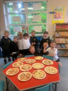 Students enjoying pizza in classroom.