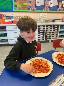 Happy child enjoying school lunch at Inchmarlo.