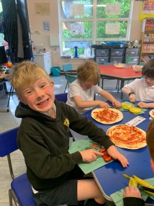 Happy student enjoying pizza in classroom.