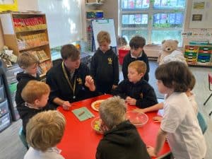 Children engaging in educational activity at Inchmarlo school classroom.
