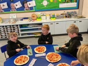 Children enjoying pizza lunch at Inchmarlo preschool.