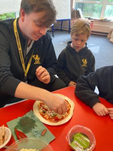 Two children baking at Inchmarlo, enjoying fun culinary activities in a warm, family-friendly environment.