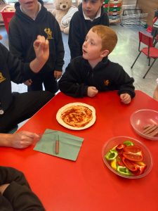 Children making pizza at Inchmarlo school.