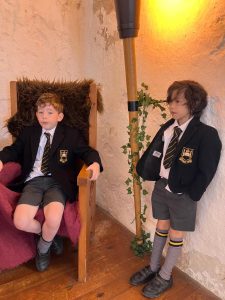 Two children in school uniforms at Inchmarlo estate, Scotland, enjoying a historical and educational setting.