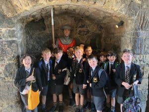 Children exploring historic site with guide.