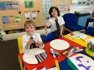 Children engaging in creative painting activity at Inchmarlo preschool.