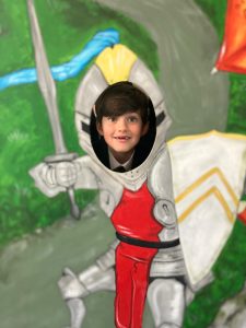 Child's face through knight mural at Inchmarlo.