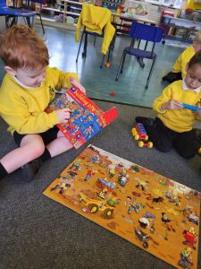 Children playing with colorful toys in a classroom setting at Inchmarlo.