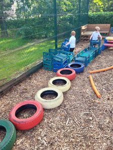 Kids playing in outdoor play zone at Inchmarlo Golf Resort Scotland, family-friendly activities.