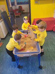 Children enjoying a game at Inchmarlo nursery with vibrant colors and engaging activities.