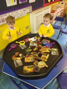 Two children engaging in educational activities at Inchmarlo nursery.