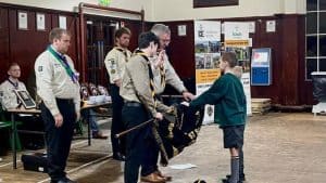 Scouts presenting awards to a young boy at Inchmarlo, highlighting community activities and youth engagement.
