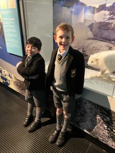 Two children in school uniforms at Inchmarlo outdoor exhibit.