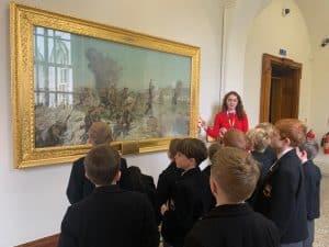 Group of children viewing art at Inchmarlo estate gallery.