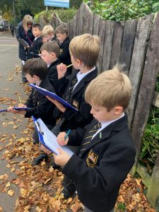 Students in school uniforms participating in outdoor educational activities at Inchmarlo, promoting learning and teamwork in a natural setting.