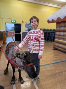 Boy with Reindeer at Inchmarlo Resort in Scotland, festive holiday spirit, family-friendly, scenic location.