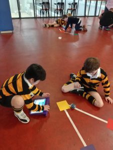 Children playing with tablets and toys in Inchmarlo's engaging indoor environment.