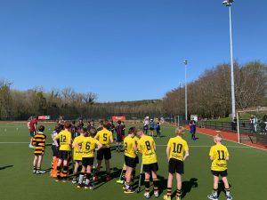 Young rugby players practicing drills at Inchmarlo sports field, focusing on youth sports training.