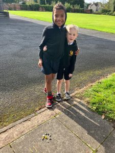 Two children smiling outdoors at Inchmarlo Gardens, Aberdeen.