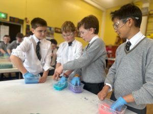Students conducting experiments in a classroom environment at Inchmarlo.