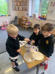 Young children engaging in a classroom activity with sensory play materials.
