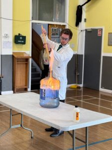 Young scientist handling a science experiment at Inchmarlo care home.