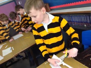 Young students in uniform working together in classroom.