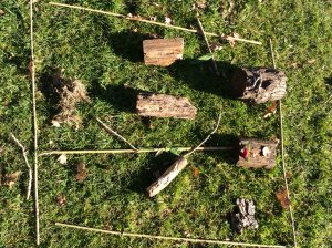 Outdoor children's playground with logs and ropes for adventurous play.