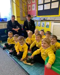 Happy children in a classroom at Inchmarlo School, engaging in learning activities in a bright, cheerful environment.