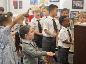 Children performing in classroom at Inchmarlo school, engaging in educational activities.