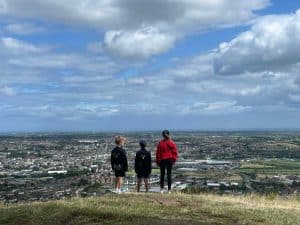 People enjoying scenic views from Inchmarlo estate under a partly cloudy sky.