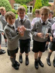 Children holding jars at Inchmarlo outdoor activity.