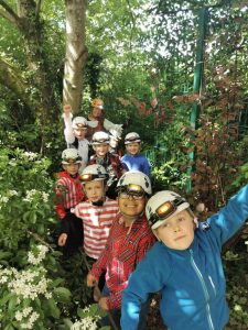 Children hiking and exploring nature at Inchmarlo outdoor activity site.