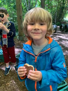 Children enjoying snacks outdoors in Inchmarlo Park, Aberdeen, Scottish countryside.