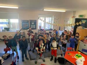 Children's classroom with kids in costumes engaging in activities.