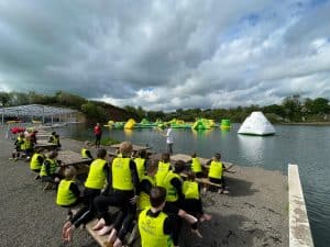 Outdoor adventure at Inchmarlo with zip lines and water activities in scenic surroundings.