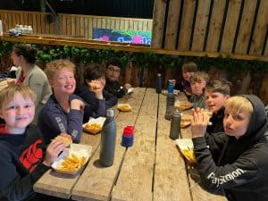 Children enjoying meal at Inchmarlo outdoor dining area in Scotland.