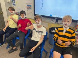 Children seated in a classroom at Inchmarlo school, engaging in learning activities in a vibrant educational environment.