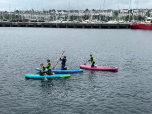 People paddleboarding on calm waters at Inchmarlo.