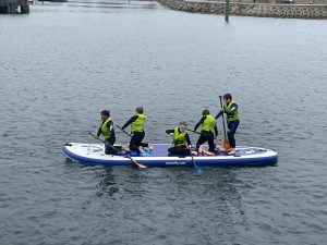Group of people paddleboarding on calm water at Inchmarlo.