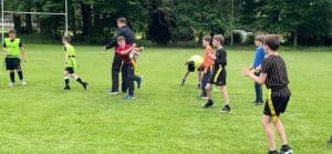 Children playing soccer on a lush green field at Inchmarlo.