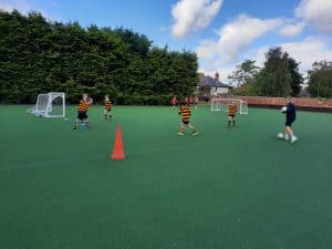 Children playing soccer on sports field at Inchmarlo, outdoor sports facility.